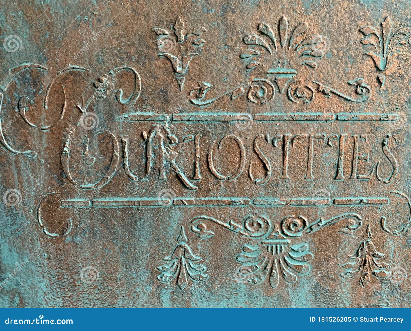 curiosities sign in bronze and verdigris